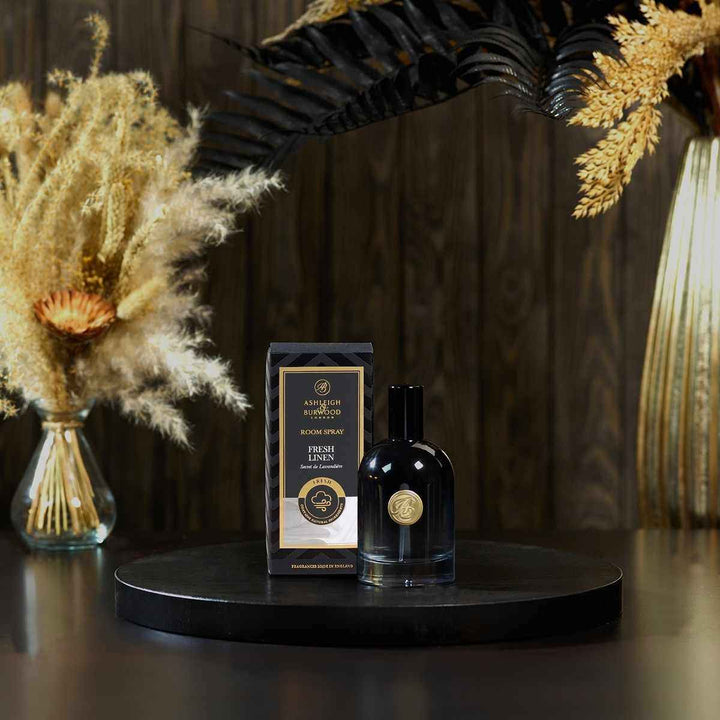 Fresh Linen Signature Room Spray with its box against a dark background