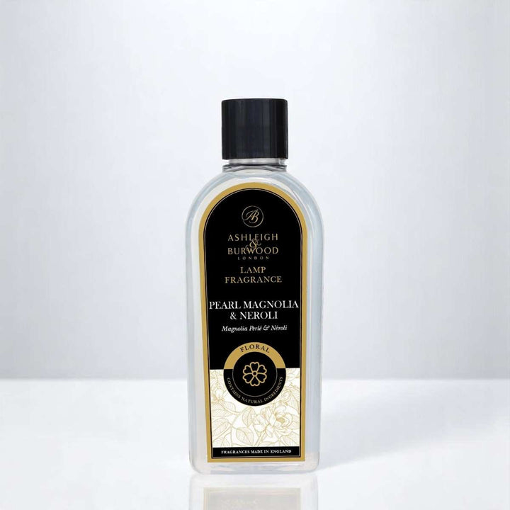 A bottle of Pearl & Magnolia Lamp Fragrance against a white neutral background