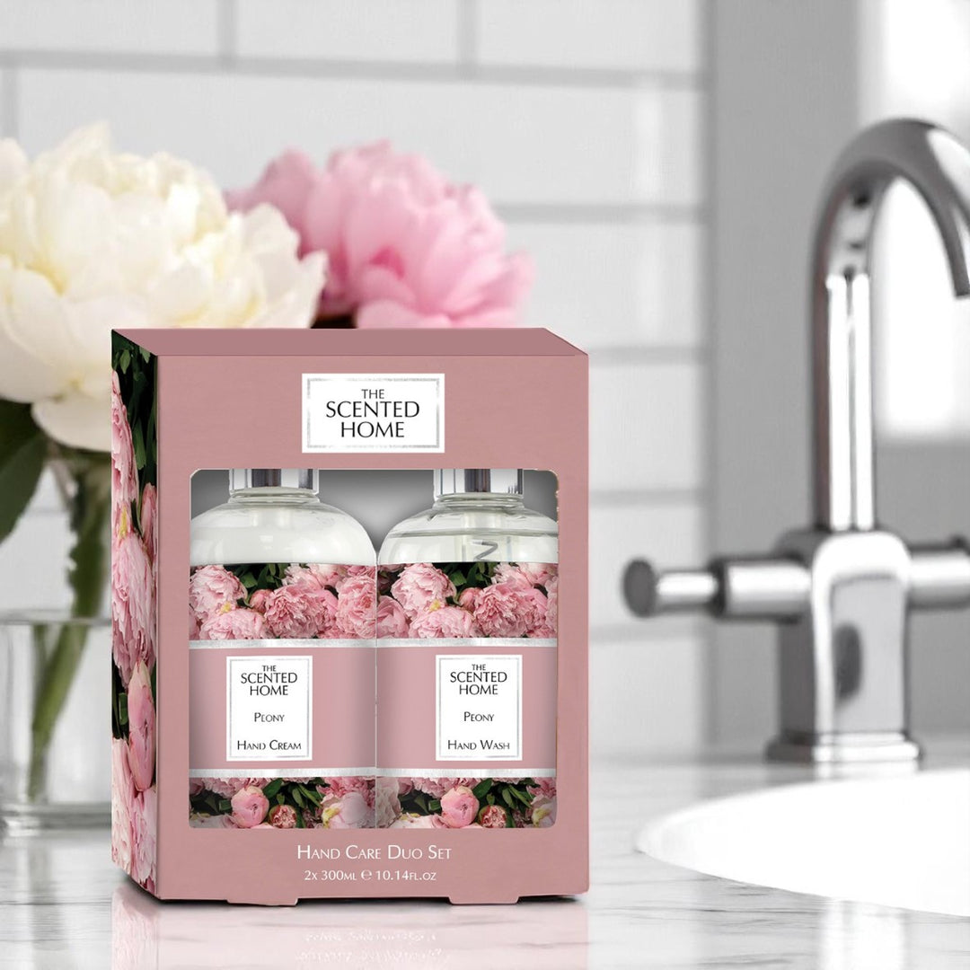 Peony Hand Care Duo Set in a bathroom with peony flowers in the background