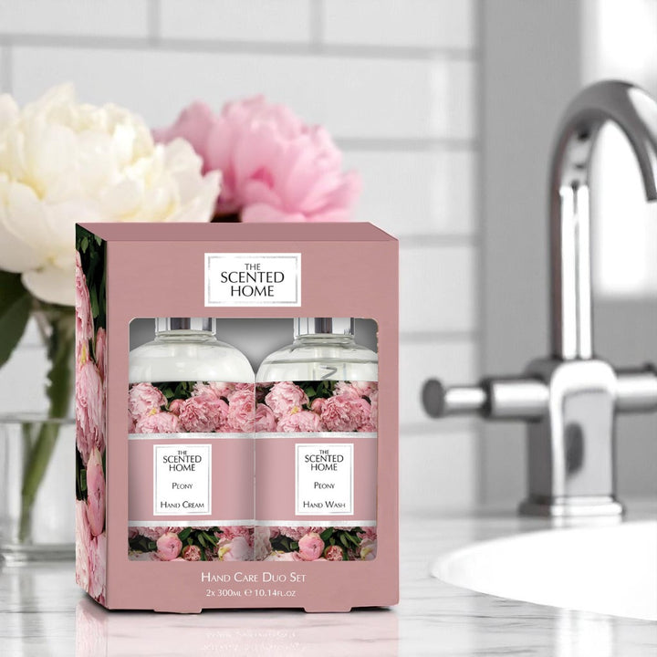 Peony Hand Care Duo Set in a bathroom with peony flowers in the background