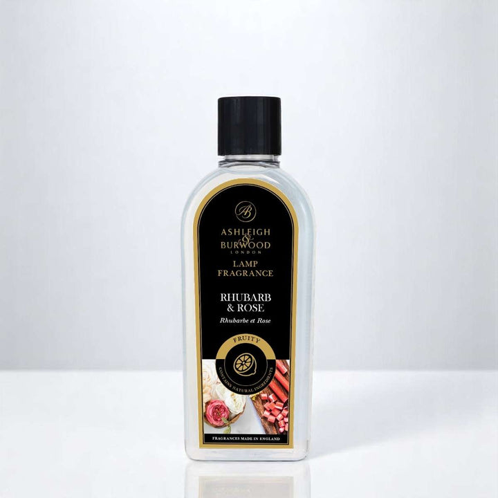 A bottle of Rhubarb & Rose Lamp Fragrance against a white neutral background