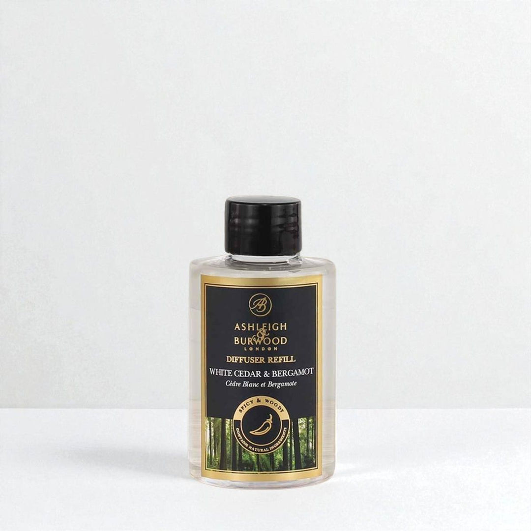 A bottle of White Cedar & Bergamot Signature Reed Diffuser Refill against a white neutral background