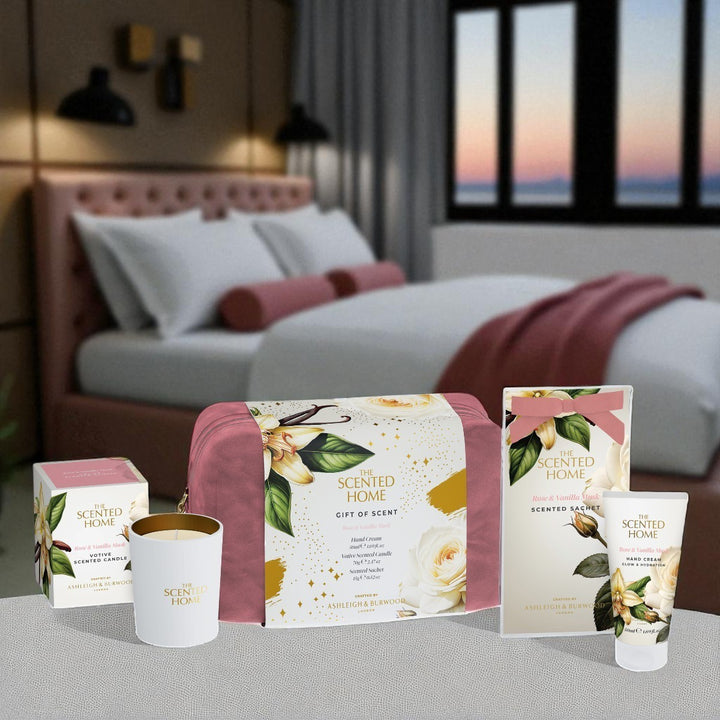 Scented home products on a table with a bedroom in the background