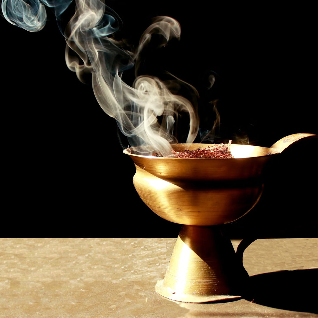 Smoky oud burning in a gold brazier