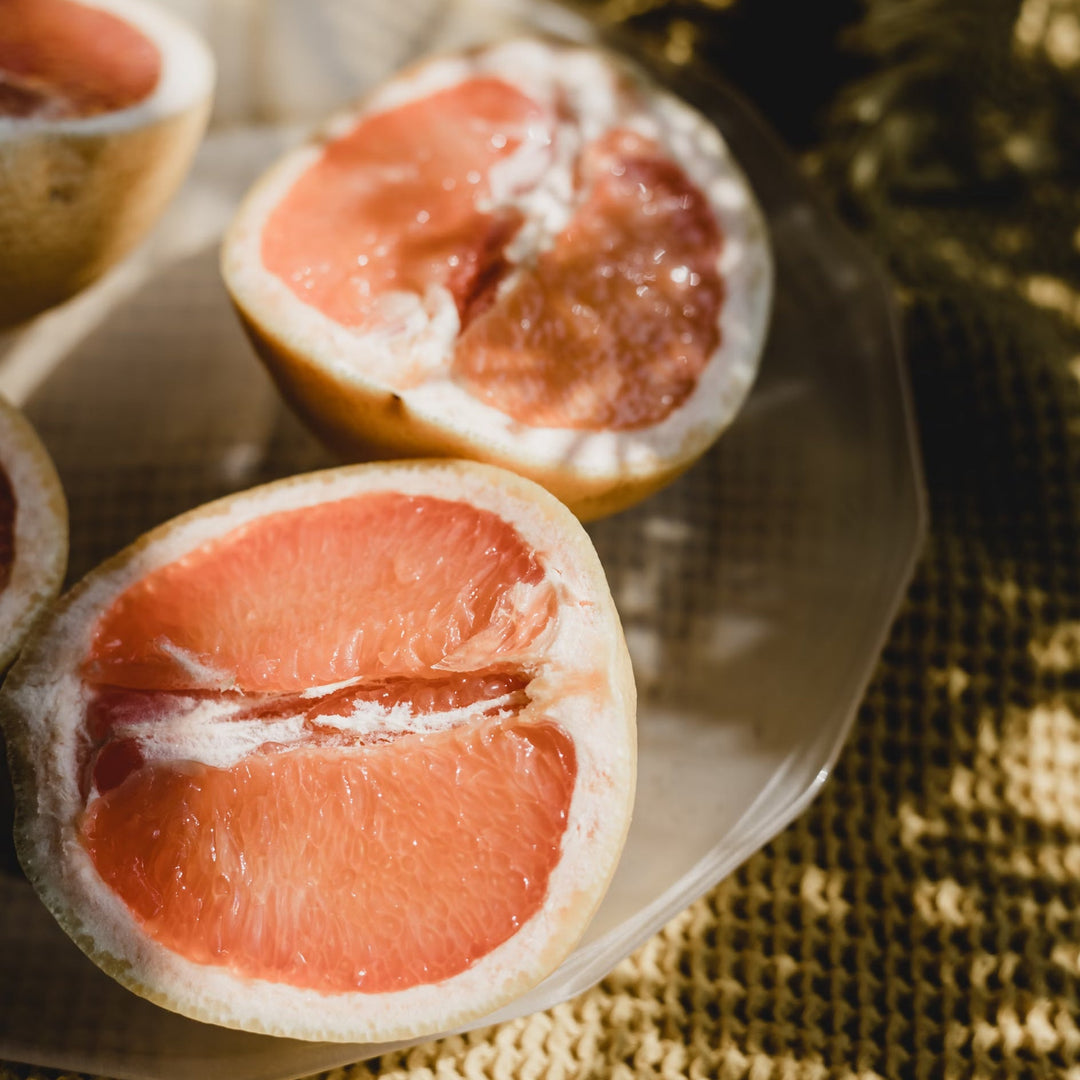 Pink grapefruit sliced in two on a table