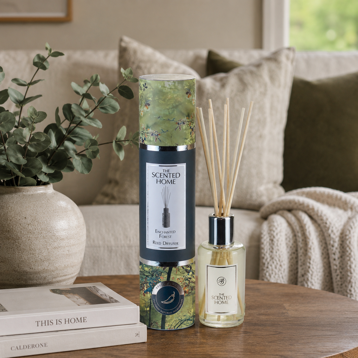 Reed diffuser set with packaging on a table in a cozy living room setting
