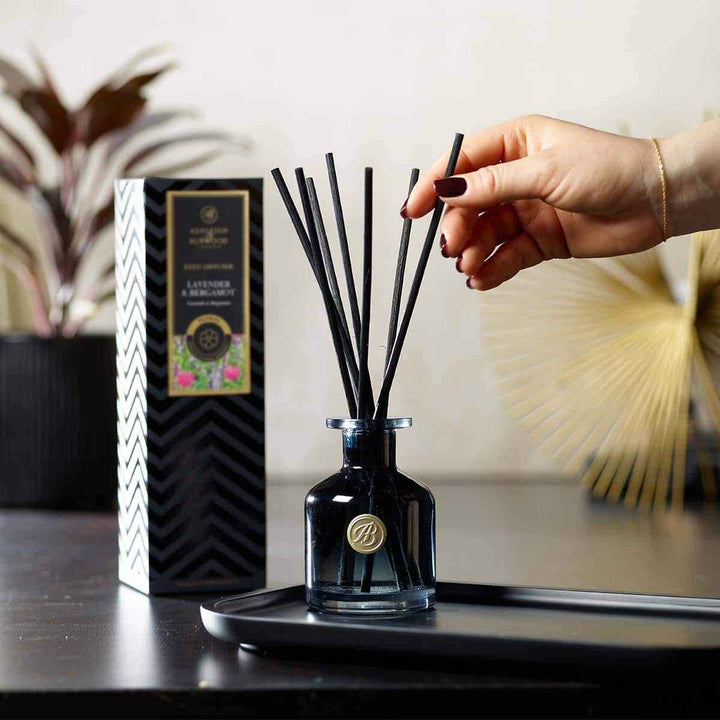 Lavender & Bergamot Signature Reed Diffuser Having Reeds Added to It