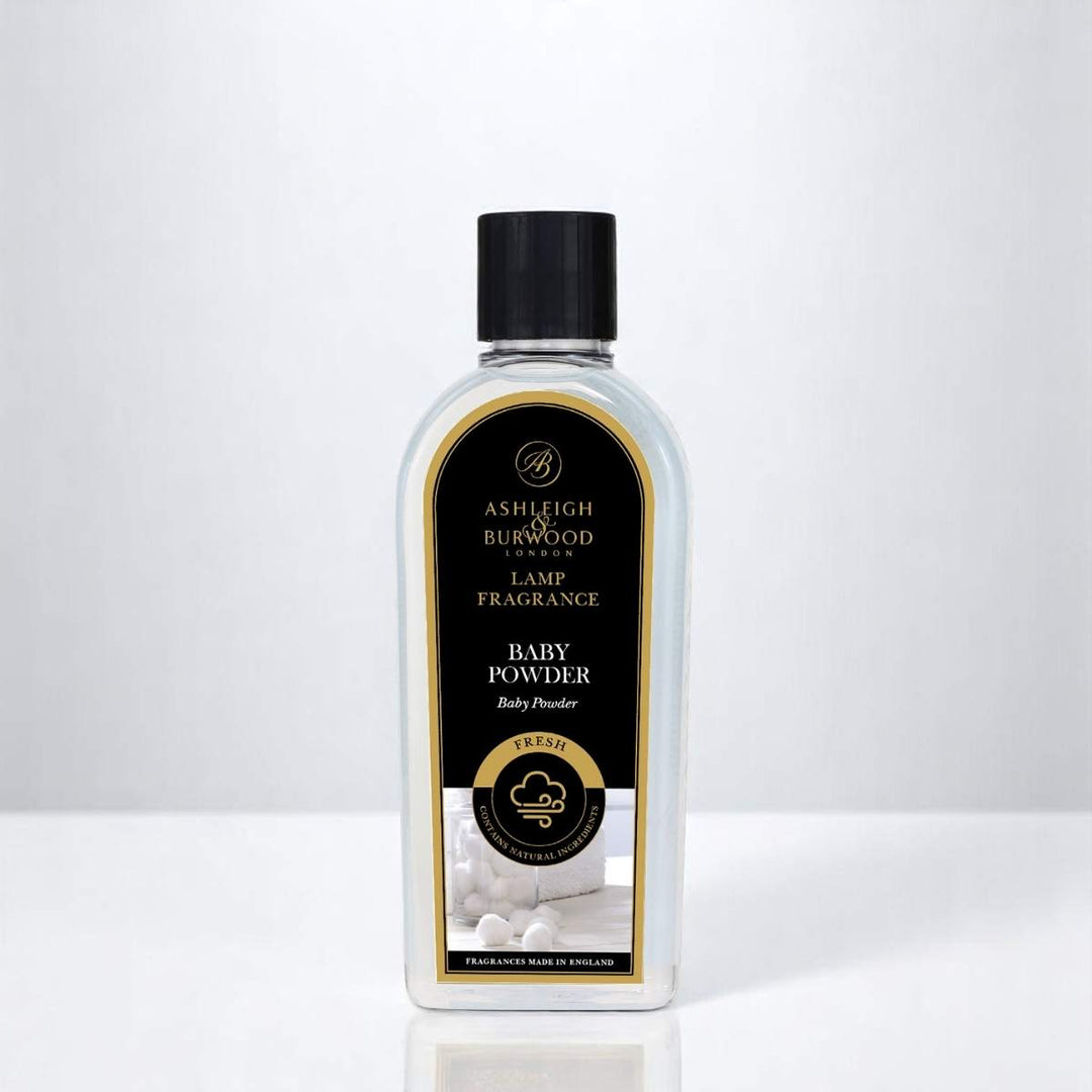 A bottle of Baby Powder Lamp Fragrance against a neutral white background