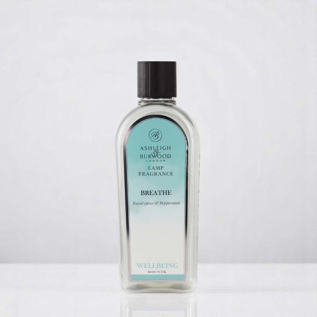 A bottle of Breathe Lamp Fragrance against a white neutral background
