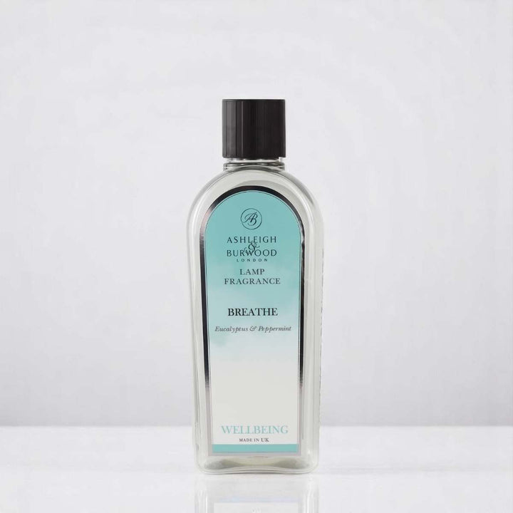 A bottle of Breathe Lamp Fragrance against a white neutral background