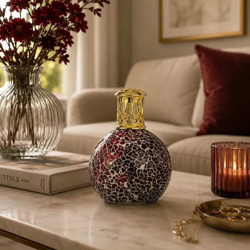 Decorative bottle with mosaic design on a marble surface in a living room setting.