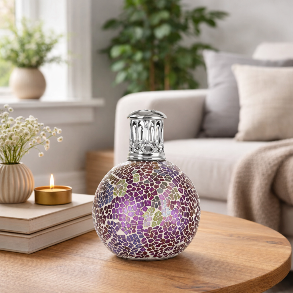 Decorative lamp with mosaic design on a wooden table in a living room setting.