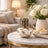Decorative lamp with gold accents on a marble table in a living room setting.