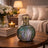 Decorative mosaic lamp on a wooden table with a cozy living room background