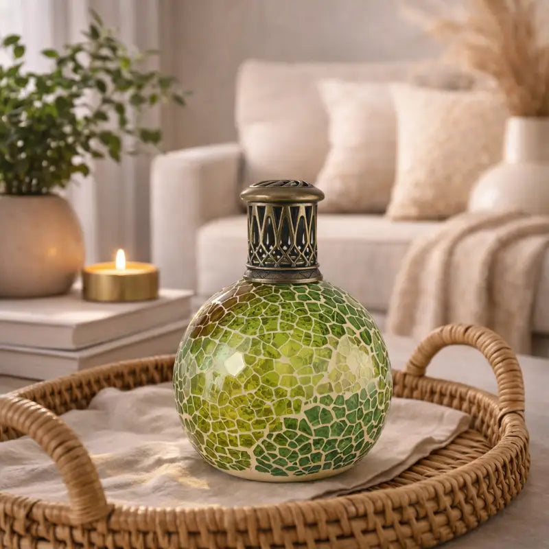 Decorative green mosaic lamp on a wicker tray with a living room background