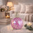 Decorative pink mosaic lamp on a table with a cozy living room background