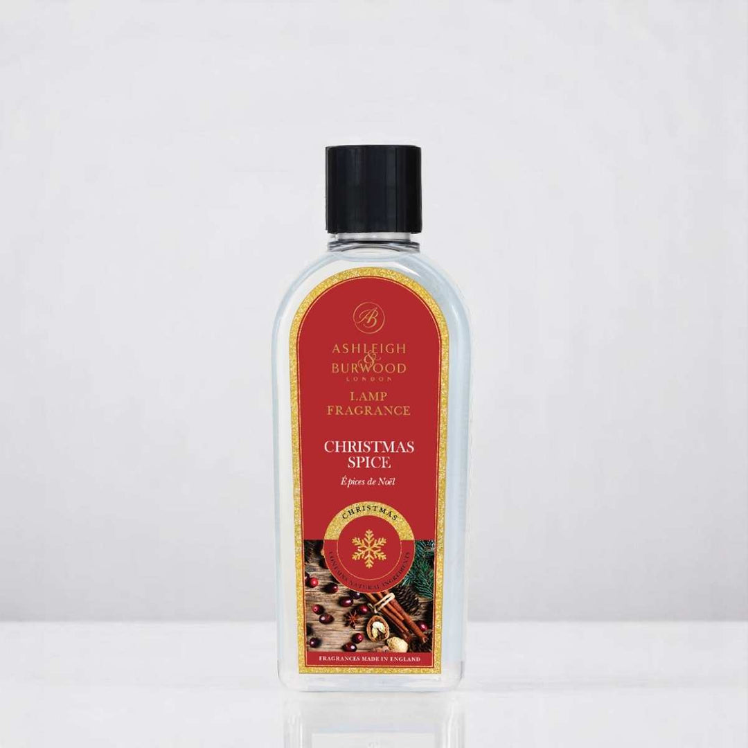 A bottle of Christmas Spice Lamp Fragrance against a white neutral background