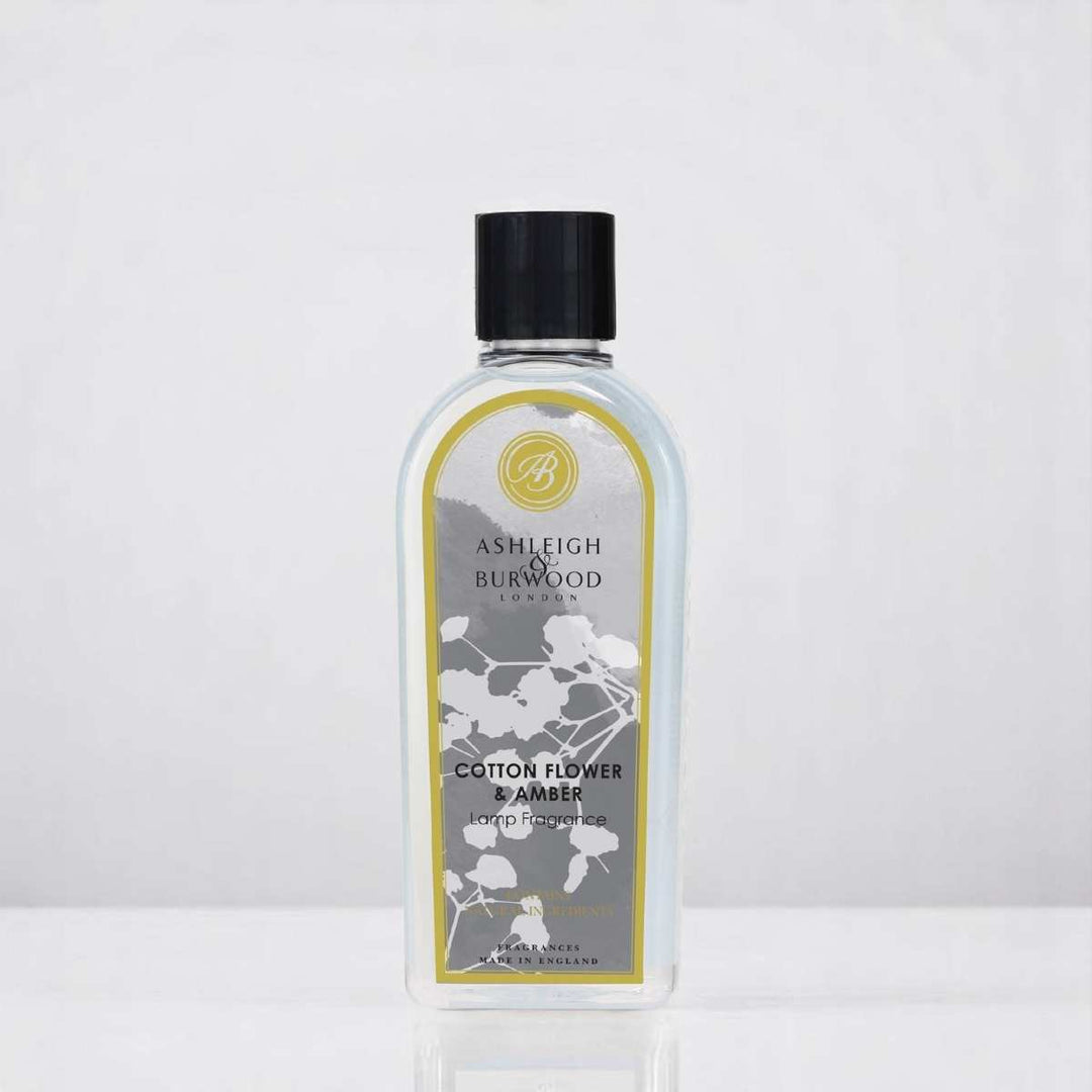 A bottle of Cotton Flower & Amber Lamp Fragrance against a white neutral background