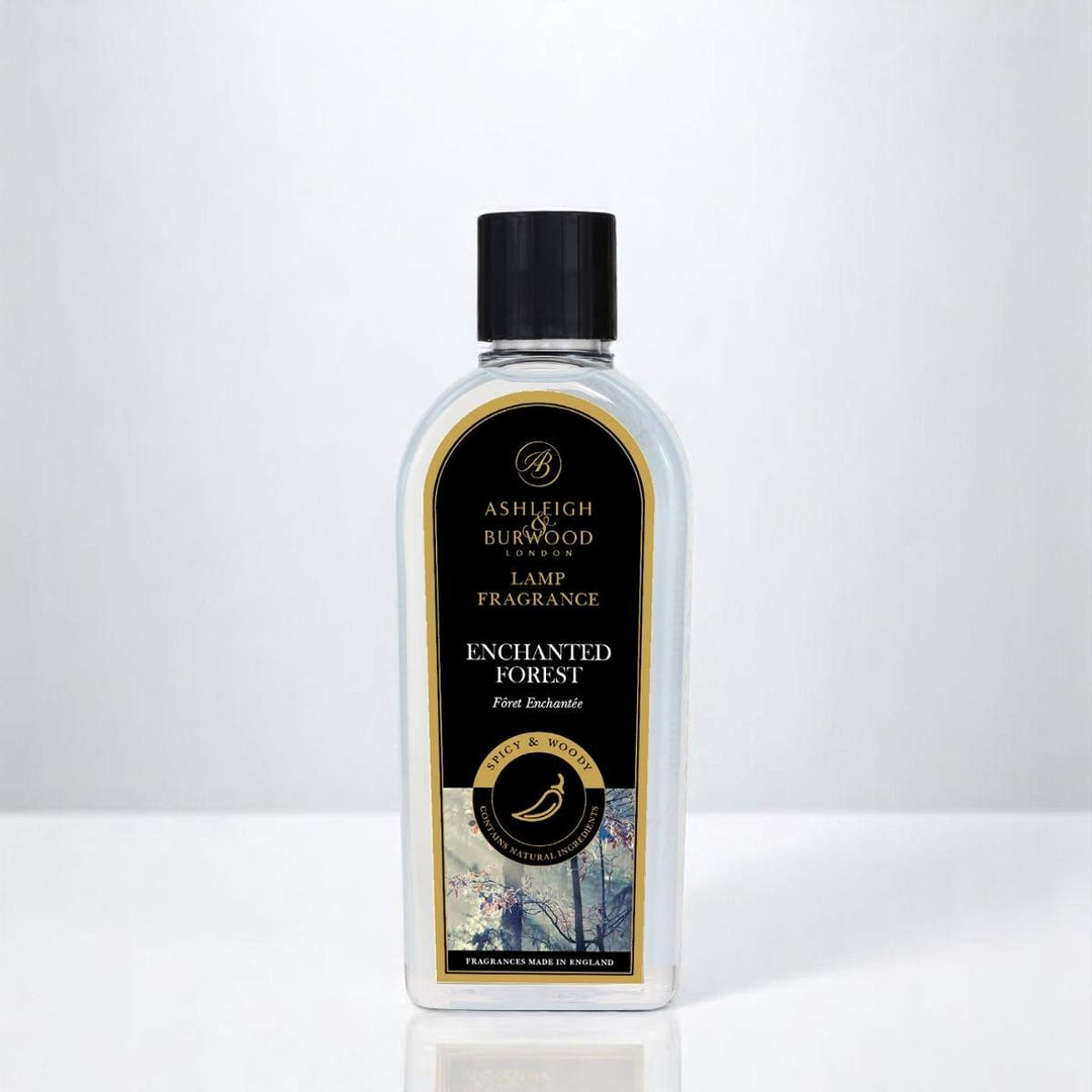 A bottle of Enchanted Forest Lamp Fragrance against a white neutral background
