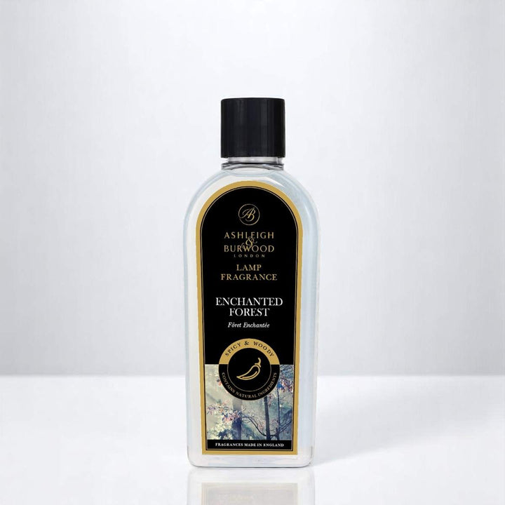 A bottle of Enchanted Forest Lamp Fragrance against a white neutral background