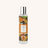 A bottle of Exotic Spices Room Spray against a white neutral background