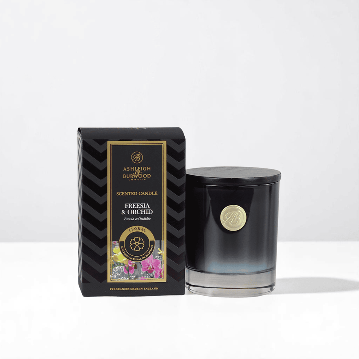 A Freesia & Orchid Signature Candle against a white neutral background