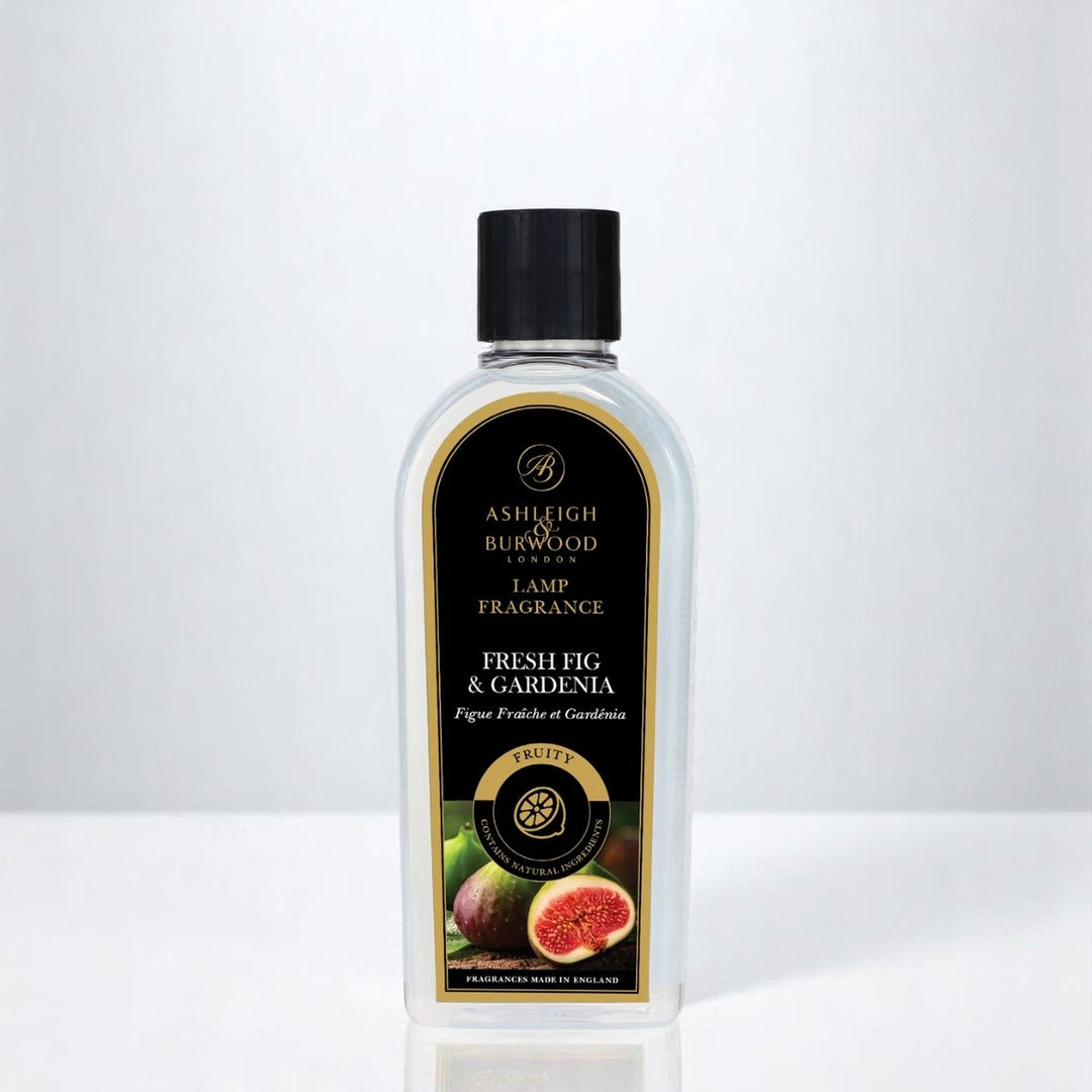 A bottle of Fresh Fig & Gardenia Lamp Fragrance against a white neutral background
