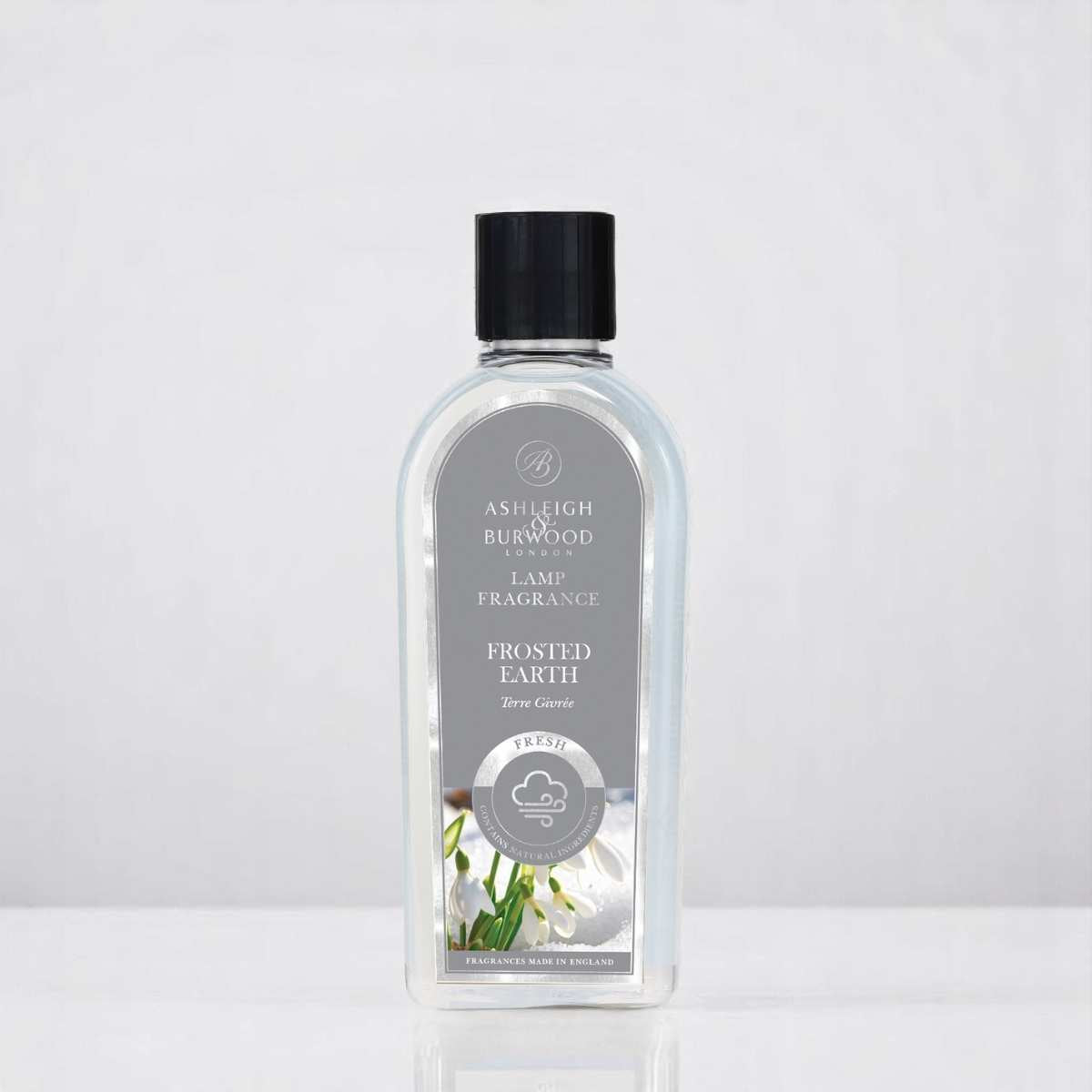 A bottle of Frosted Earth Lamp Fragrance against a white neutral background