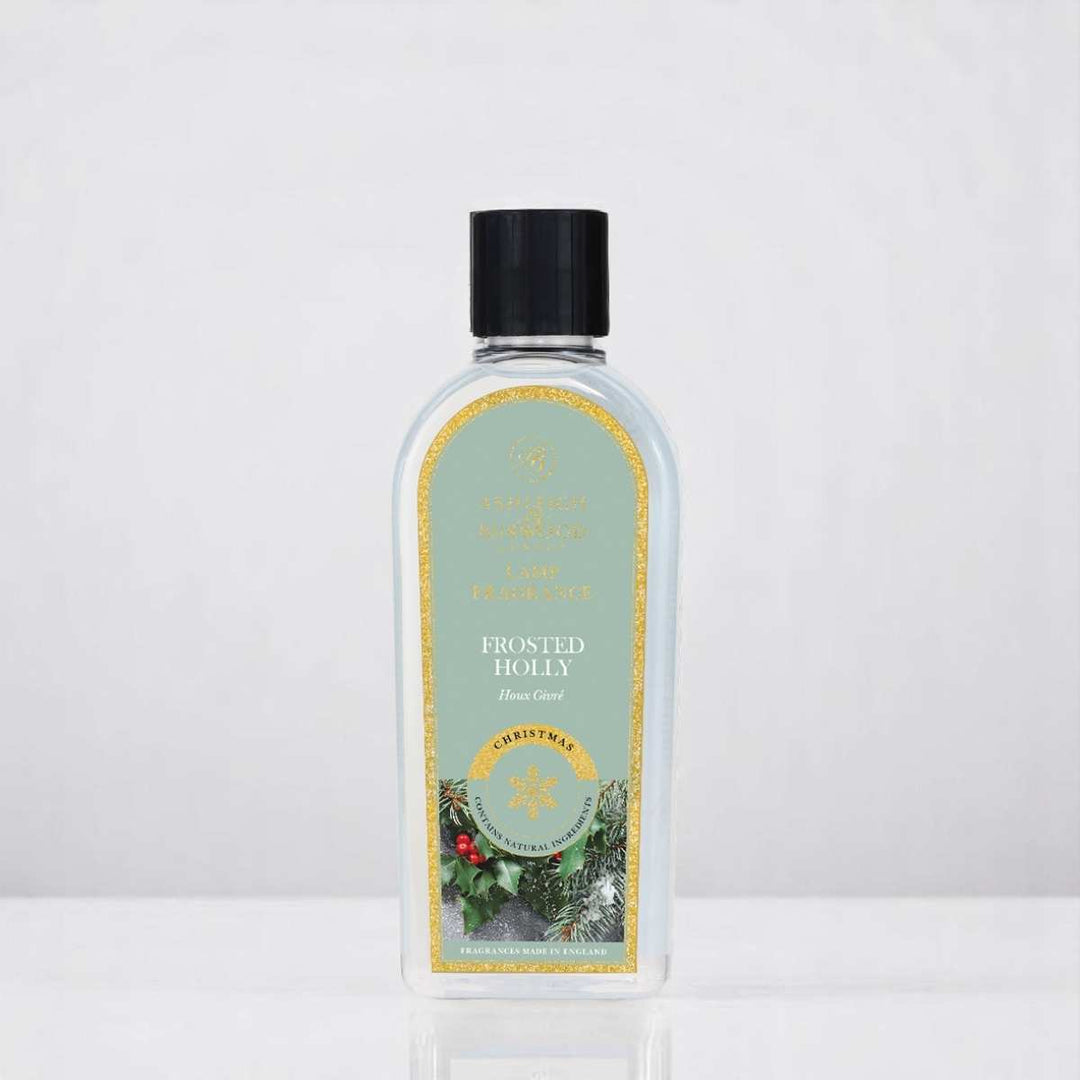 A bottle of Frosted Holly Lamp Fragrance against a white neutral background
