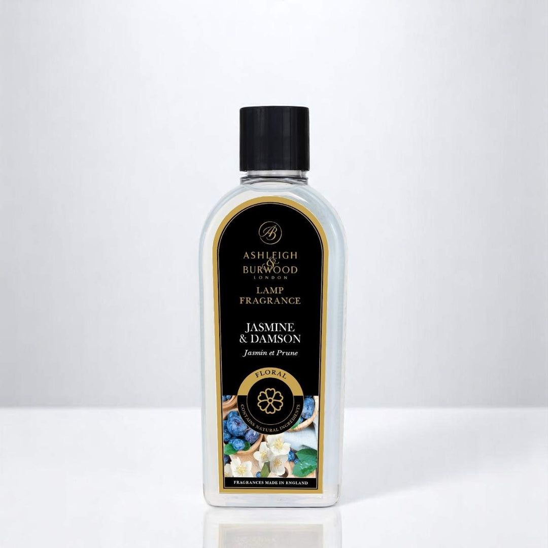 A bottle of Jasmine & Damson Lamp Fragrance against a white neutral background