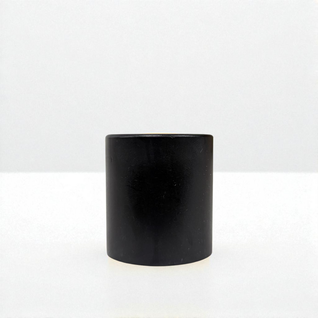 Black cylindrical object on a white background