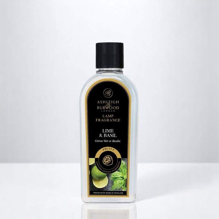 A bottle of Lime & Basil Lamp Fragrance against a white neutral background