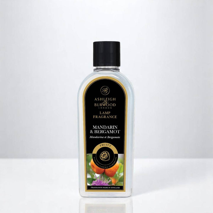 A bottle of Mandarin & Bergamot Lamp Fragrance against a white neutral background