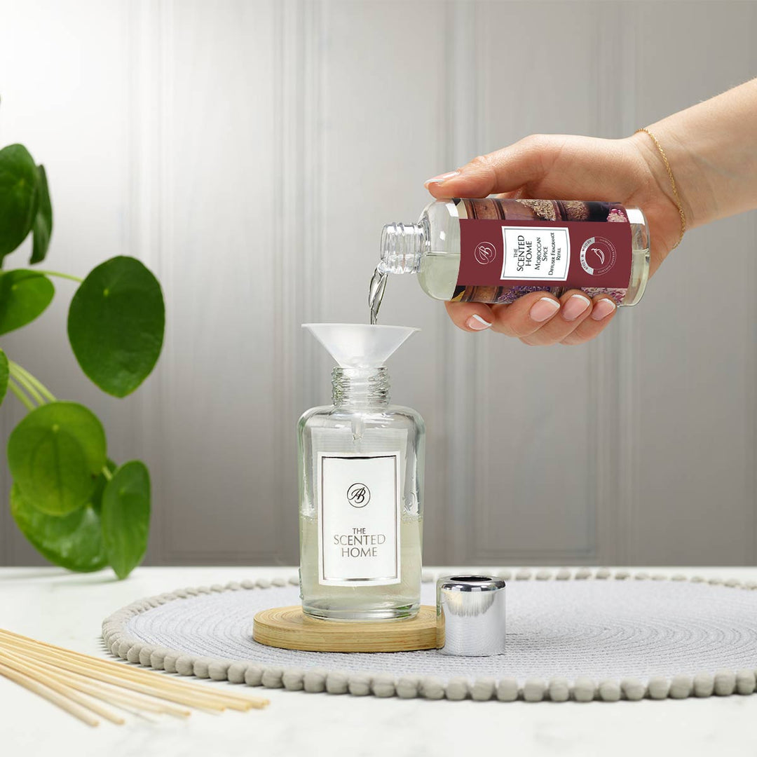 Moroccan Spice Reed Diffuser Refill being poured into vessel