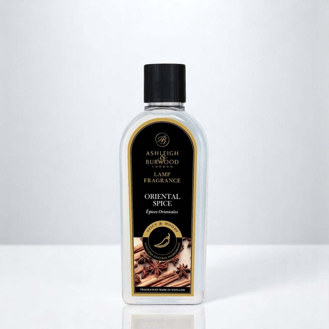 A bottle of Oriental Spice Lamp Fragrance against a white neutral background