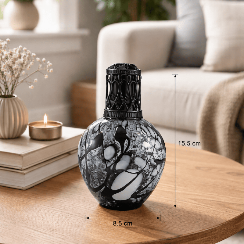 Decorative black and white vase on a wooden table with measurements indicated