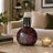 Decorative vase with mosaic design on a coffee table in a living room setting