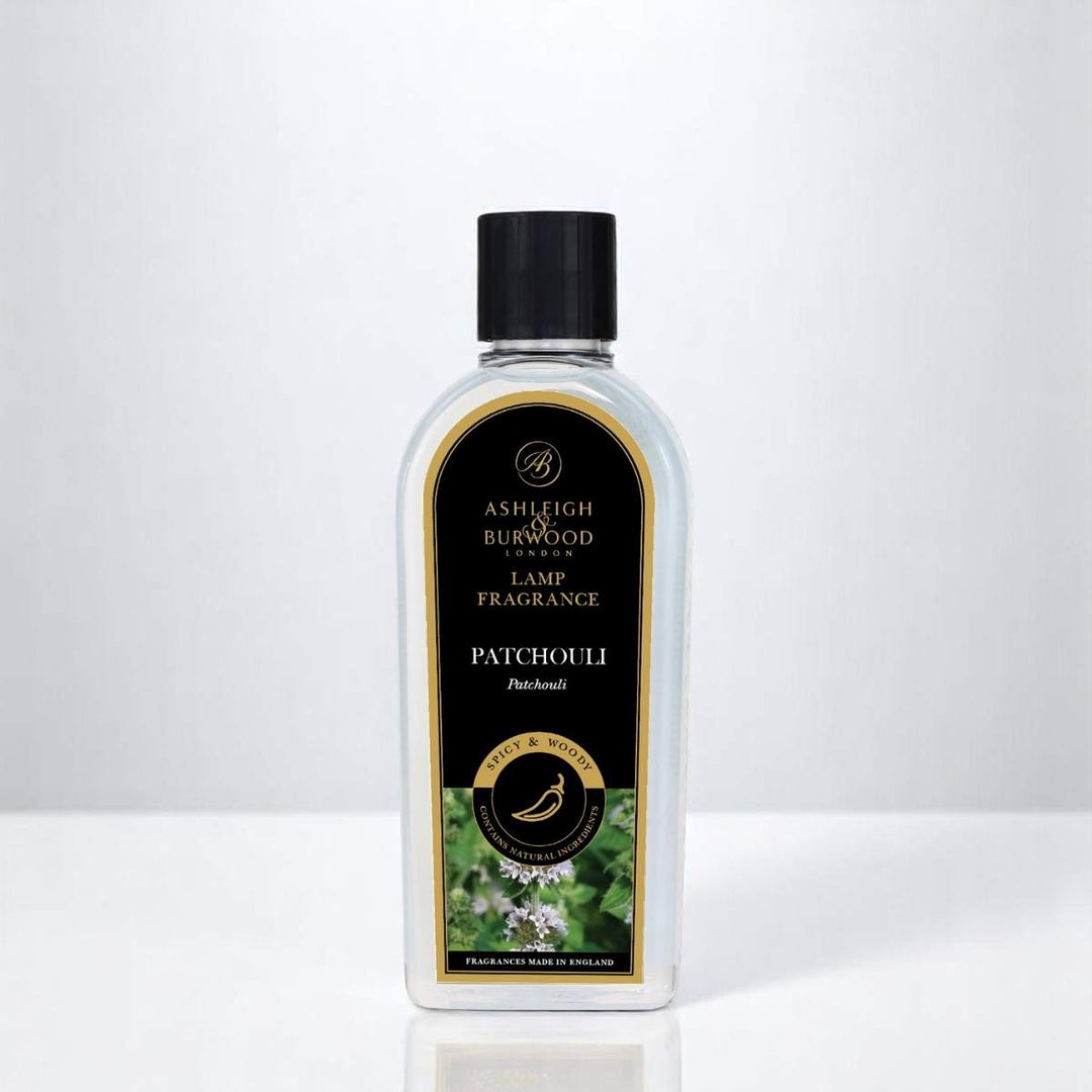 A bottle of Patchouli Lamp Fragrance against a white neutral background