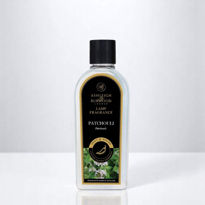 A bottle of Patchouli Lamp Fragrance against a white neutral background