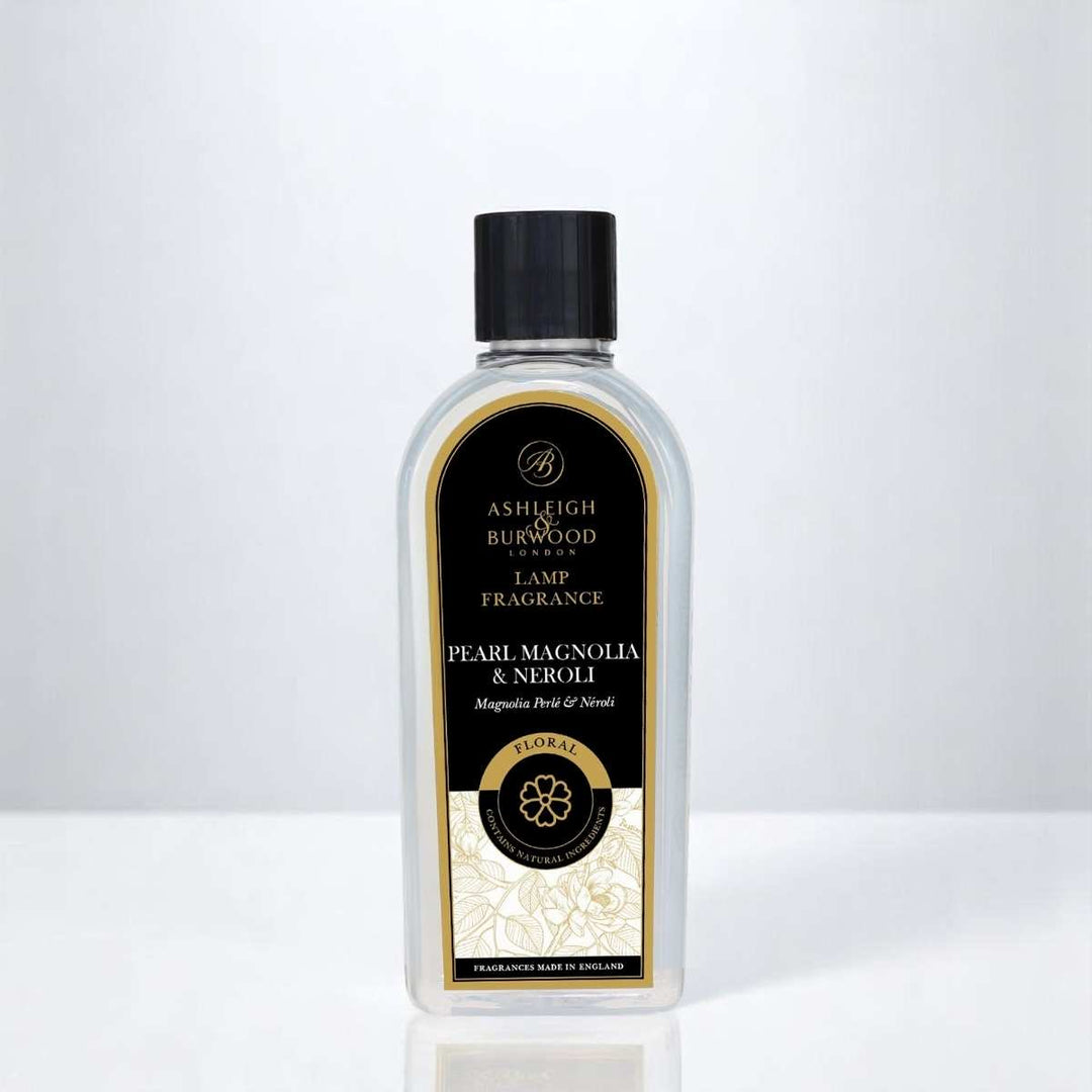 A bottle of Pearl & Magnolia Lamp Fragrance against a white neutral background