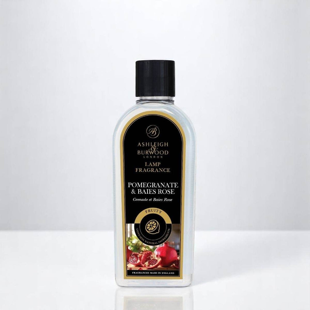 A bottle of Pomegranate & Baies Rose Lamp Fragrance against a white neutral background