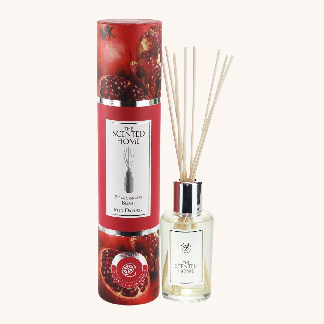 Pomegranate blush reed diffuser with packaging on a white background