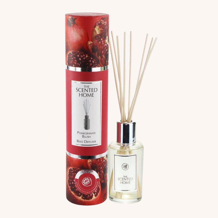 Pomegranate blush reed diffuser with packaging on a white background
