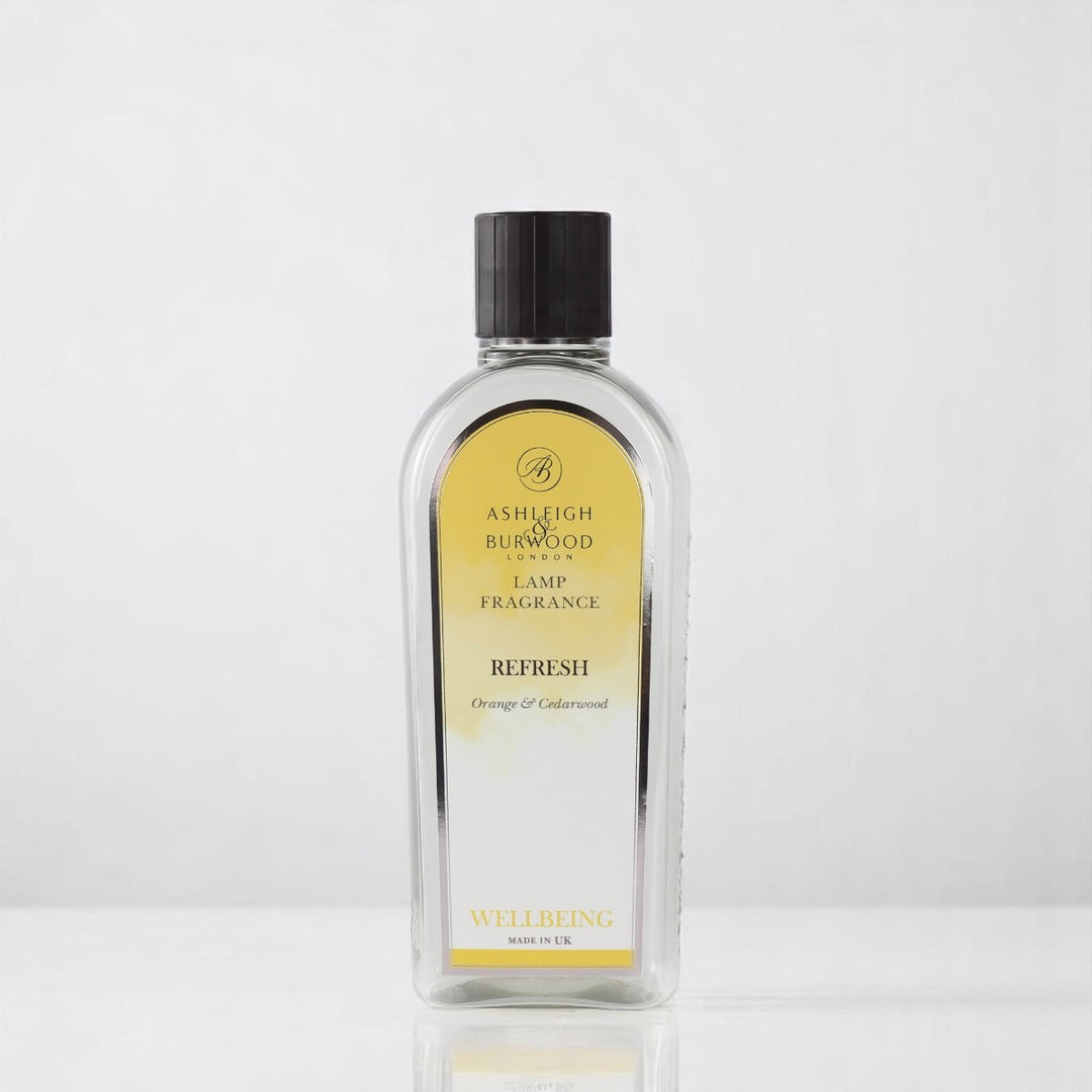 A bottle of Refresh Lamp Fragrance against a white neutral background