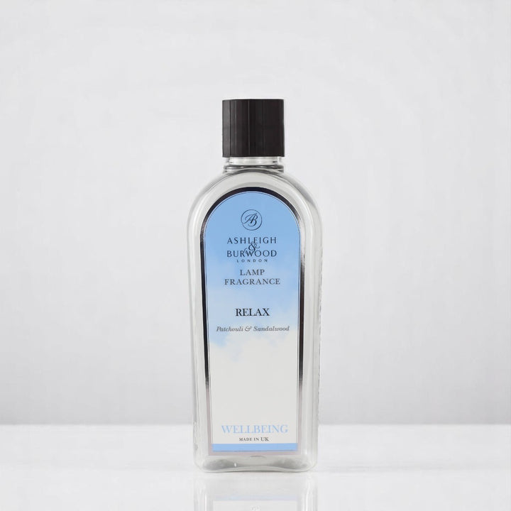 A bottle of Relax Lamp Fragrance against a white neutral background