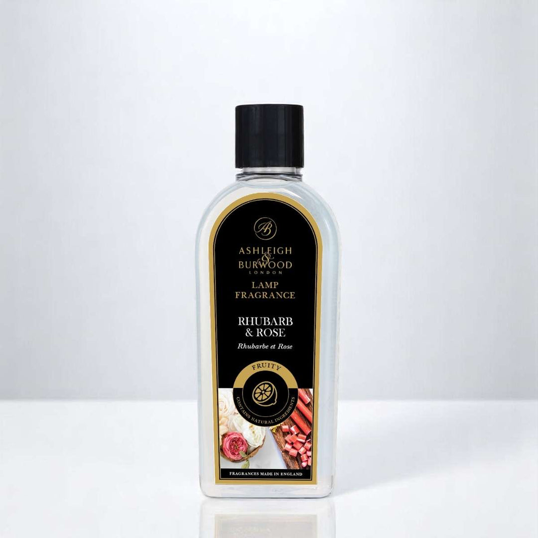 A bottle of Rhubarb & Rose Lamp Fragrance against a white neutral background
