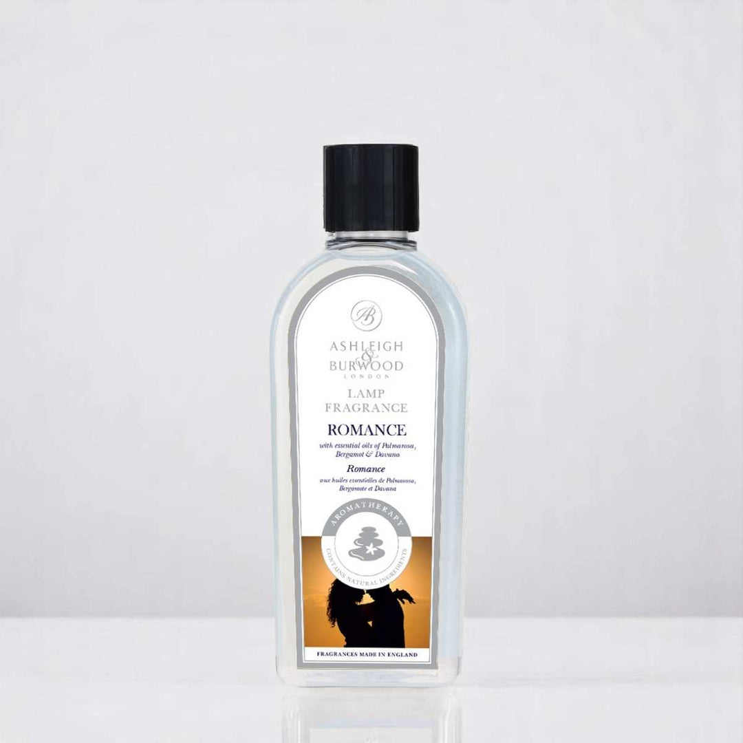 A bottle of Romance Lamp Fragrance against a white neutral background