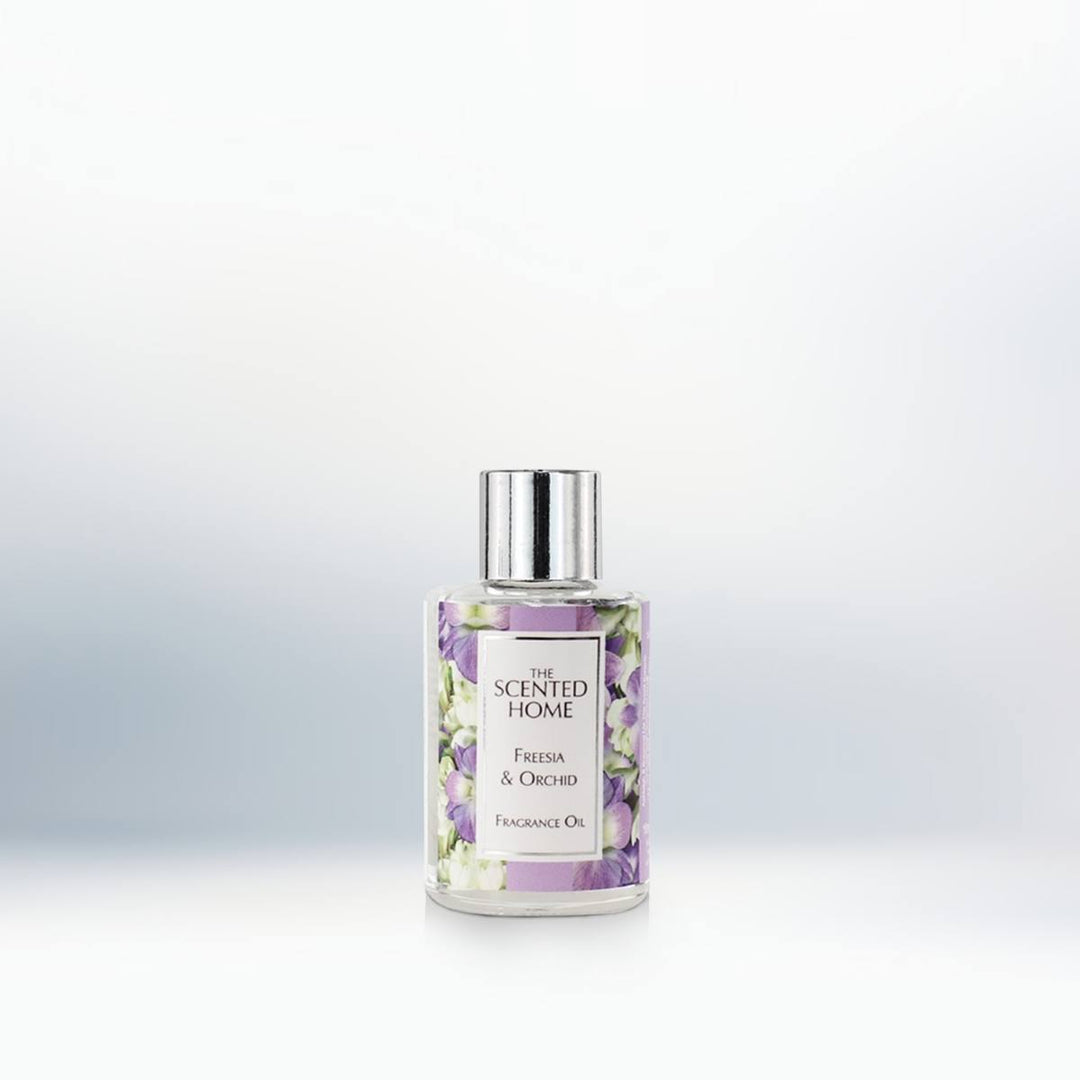 A picture of a bottle of Freesia & Orchid Fragrance oil against a neutral background