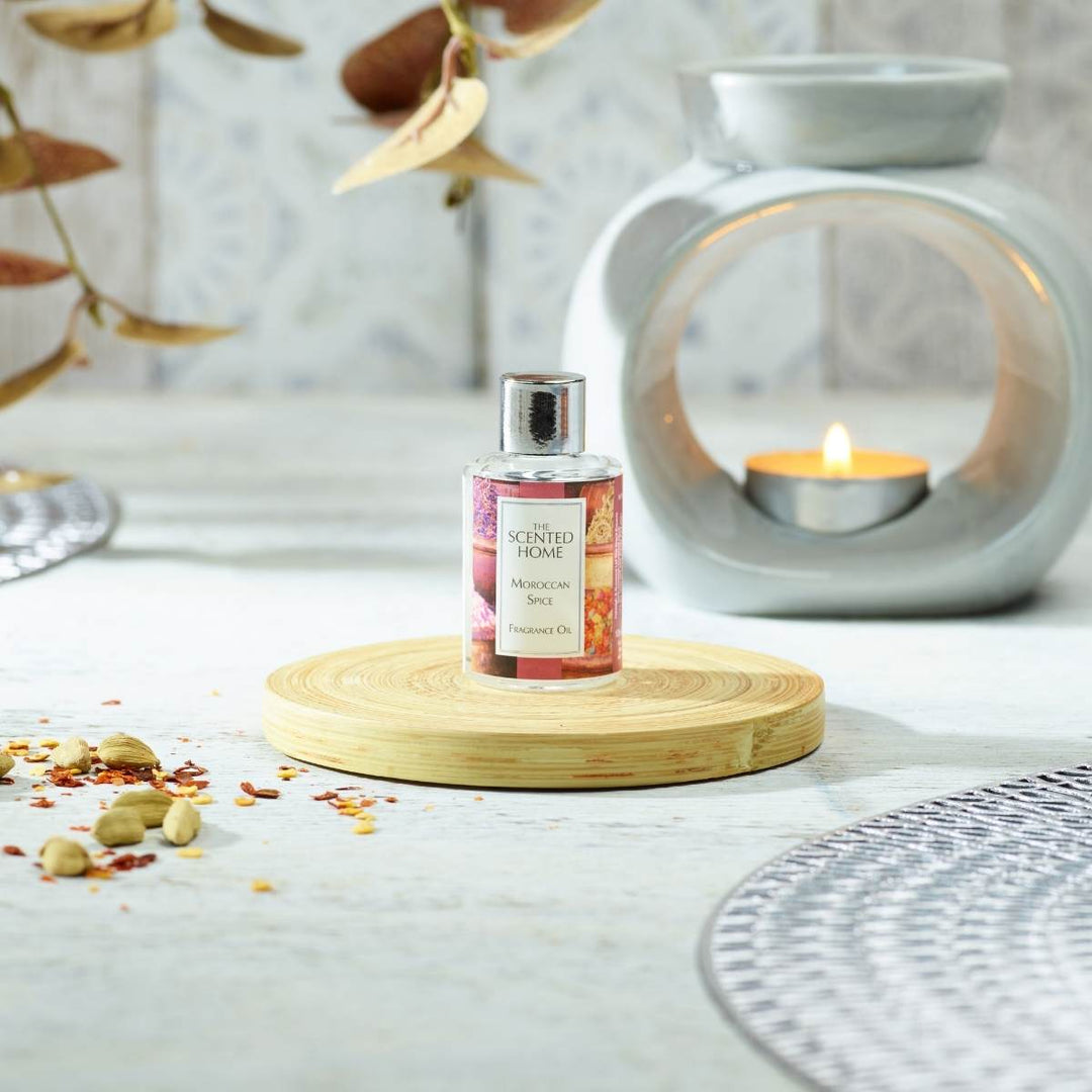 Moroccan Spice Fragrance Oil in the foreground with a burning Oil Burner in the background