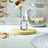 Enchanted Forest Fragrance Oil in the foreground with a lit Oil Burner in the background